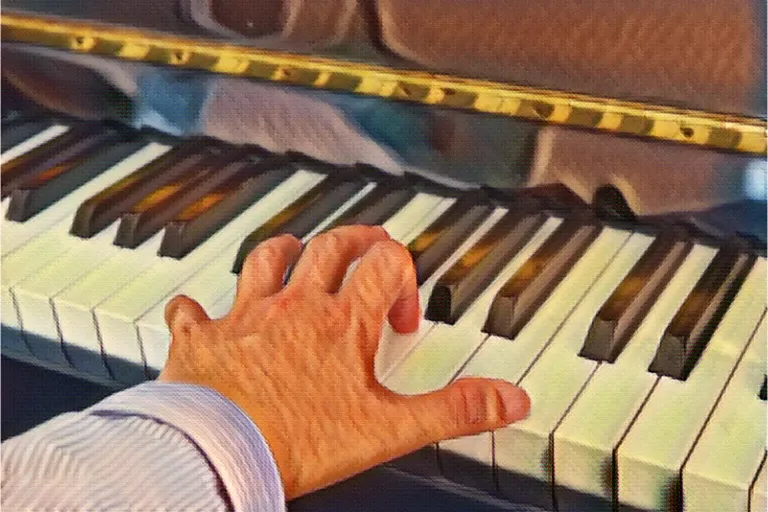 left hand on piano keyboard