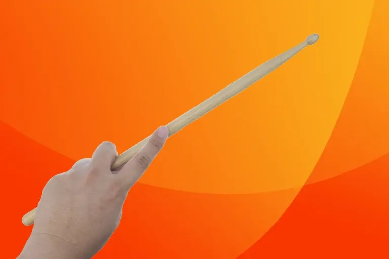 left hand holding drumstick on orange gradient background