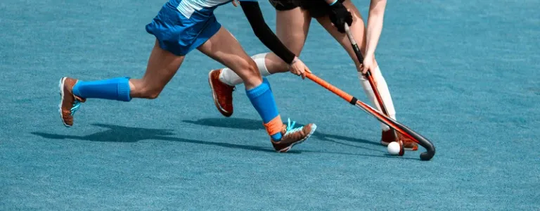 left-handed field hockey player in action